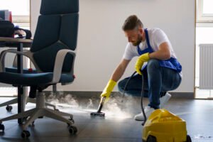 professional cleaning service person using steam cleaner office